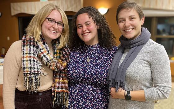 Katie Gordon, left, and Benedictine Sisters Jacqueline Sanchez-Small and Val Luckey, are pictured during now-Sister Sanchez-Small's first profession ceremony with the Benedictine community of Erie, Pennsylvania, on Nov. 13, 2021. (CNS/Courtesy of Global Sisters Report/Katie Gordon)