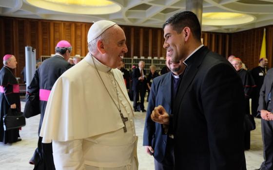 Francis and Dorantes face each other smiling in conversation. 