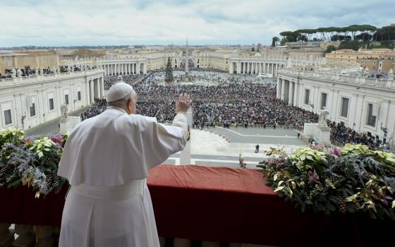 Pope Francis waves to an estimated 70,000 people gathered in St. Peter's Square at the Vatican for his Christmas blessing "urbi et orbi" (to the city and the world) Dec. 25, 2023. (CNS photo/Vatican Media)