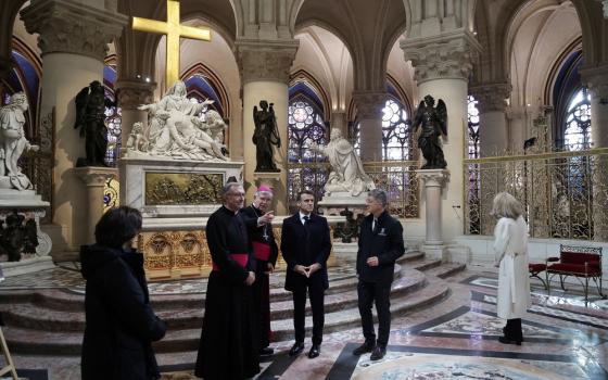 The President, First Lady with two prelates and two other persons stand in front of the monumental Pieta.