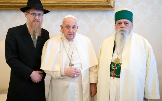 Pope Francis, wearing a sling on his right arm after a fall, poses for a photo with Edmond Brahimaj, right, leader of the Bektashi community of Muslim Sufis from Tirana, Albania, during a meeting at the Vatican Jan. 16, 2025. The Vatican said the pope injured his arm in a fall and while nothing was broken, the arm was immobilized as “a cautionary measure.” (CNS photo/Vatican Media)