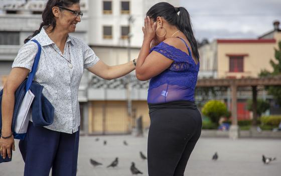 Sr. Angélica Segoviano, an Oblate of the Most Holy Redeemer, visits Wendy Cadina a few times a month at the park where Cadina loiters to sell sex. They talk about Cadina's life and children, and Segoviano sometimes talks about job opportunities outside of prostitution. (Courtesy of Lisa Kristine) 