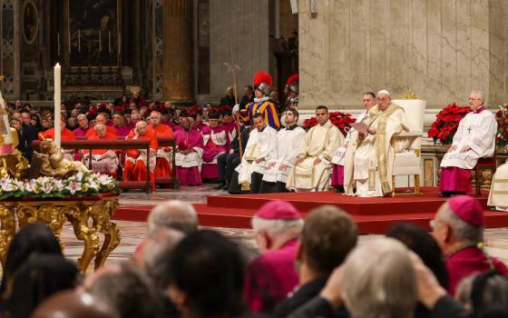 Pope Francis, after opening the Holy Door of St. Peter's Basilica at the Vatican, gives his homily during the Christmas Mass at Night Dec. 24, 2024. (CNS photo/Lola Gomez)