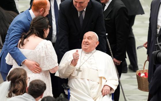  Pope Francis blesses a newlywed couple expecting a child during his weekly general audience in the Paul VI Audience Hall at the Vatican Feb. 12, 2025. (CNS photo/Lola Gomez)