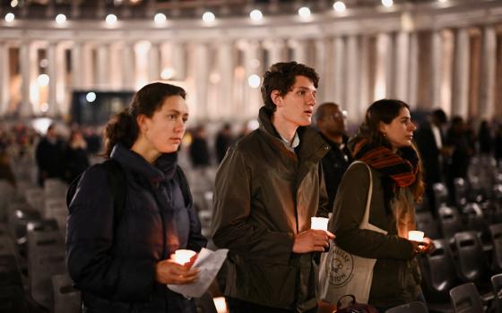 People join in reciting the rosary for Pope Francis in St. Peter's Square at the Vatican Feb. 24, 2025. 