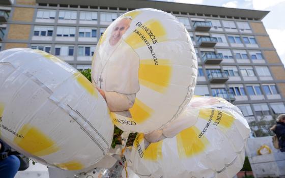 Balloons featuring an image of Pope Francis are seen outside Rome’s Gemelli hospital Feb. 27, 2025, while the pope is being treated there for double pneumonia. (CNS photo/Lola Gomez)