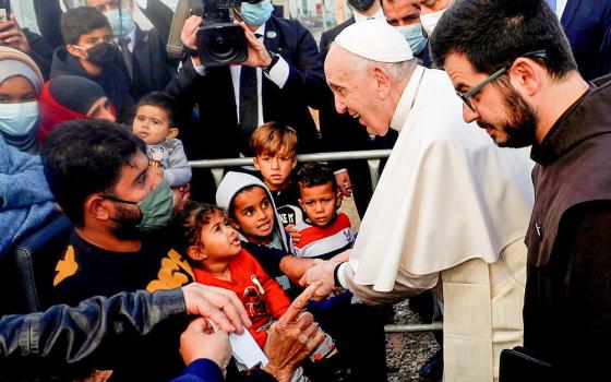 Pope Francis meets migrants during his visit to the Mavrovouni camp for refugees and migrants on the island of Lesbos, Greece, Dec. 5, 2021. (CNS/Reuters/Guglielmo Mangiapane)