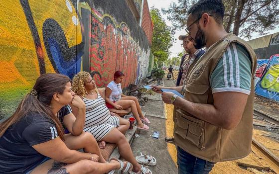 Workers from CAFEMIN, a shelter for women and families run by Josephine sisters in Mexico City, check in on the welfare of migrants living in a camp near the train tracks. Some were weighing returning home since they said they can't head north to the U.S., and Mexico makes it difficult for them to obtain documents to work and survive. (GSR photo/Rhina Guidos)