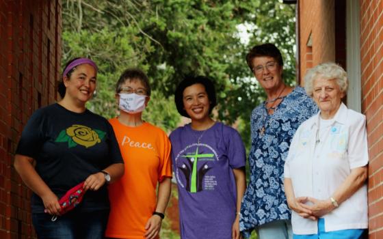 Outside the back door of the New Haven Dominicans of Peace convent, from left, Srs. Ana Gonzalez, June Fitzgerald, Lovers of the Holy Cross Sr. AnHoa Nguyen (a visiting scholar from Vietnam), Dominican candidate Cathy Buchanan, and Sr. Julia Grey