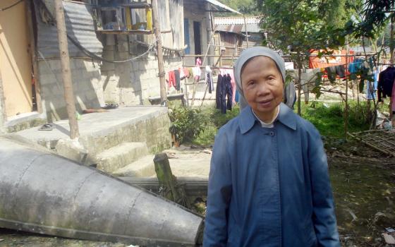 St. Paul de Chartres Sr. Ephrem Nguyen Thi Luu, 76, visits poor families who live on river banks in Hue City. (Peter Nguyen)