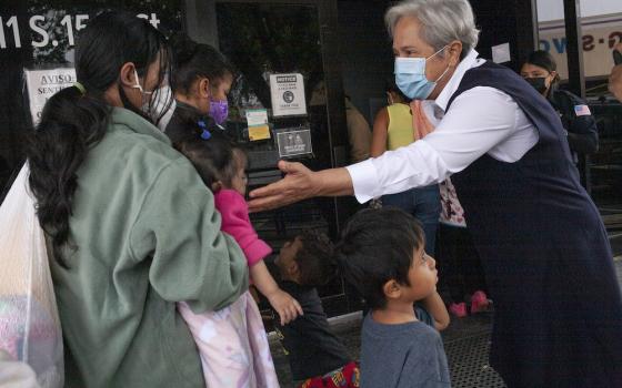 Sr. Norma Pimentel, a member of the Missionaries of Jesus and executive director of Catholic Charities of the Rio Grande Valley, greets newly arrived immigrants March 23 at the Humanitarian Respite Center in McAllen, Texas. (Nuri Vallbona)