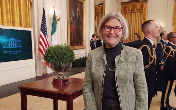 Social Service Sr. Simone Campbell poses with a bowl of shamrocks, a gift from the nation of Ireland to the United States, on March 17 [2022] at a St. Patrick's Day celebration at the White House in Washington, D.C. (Courtesy of Sr. Simone Campbell)