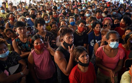 Residents wait for relief goods at an evacuation center in Manila, Philippines, Nov. 13, following Typhoon Vamco. Five tropical storms or typhoons have hit the Philippines in a three-week period, including the strongest typhoon since 2013 and the biggest 