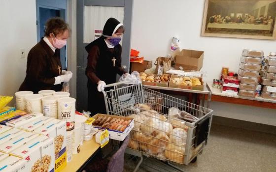 Deo Gratias Ministries Detroit co-directors Sr. Shelley Marie Jeffrey, left, and Sr. Felicity Marie Madigan sort and organize supplies in the food pantry. (Courtesy of the Felician Sisters of North America)