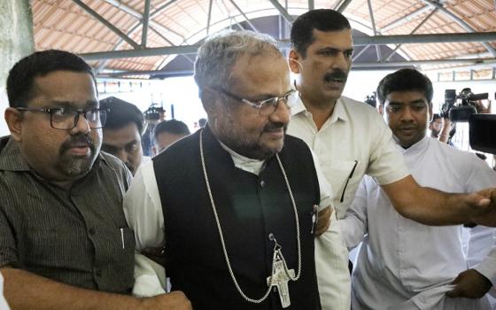 Bishop Franco Mulakkal of Jalandhar, center, enters the portico of the Additional District and Sessions Court in Kottayam, Kerala, Nov. 30, 2019, to stand trial in the rape of a nun. (M.A. Salam)