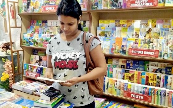 A young woman looks through the books at the Pauline Books and Media Center in Goa, India. (Lissy Maruthanakuzhy)