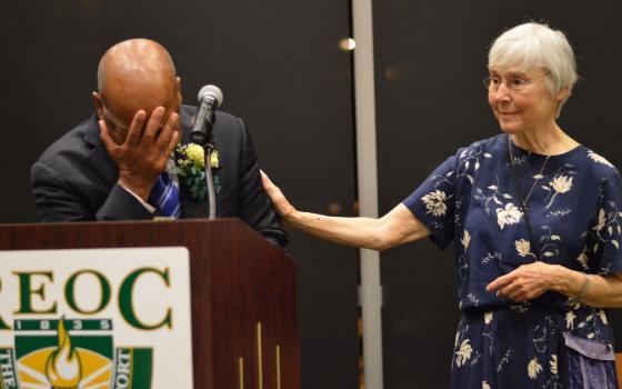 St. Joseph Sr. Barbara Lum, right, comforts U.S. Rep. John Lewis at the Rochester Education Opportunity Center's graduation ceremony May 13, 2014, as he speaks about the sisters who cared for him on Bloody Sunday in 1965. Lum was on the center's nursing f