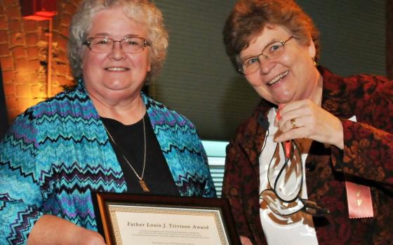 Sr. Kate Kuenstler of the Poor Handmaids of Jesus Christ, left, seen with St. Joseph Sr. Christine Schenk, receives FutureChurch's Rev. Louis J. Trivison Award in fall 2012. (Courtesy of FutureChurch)