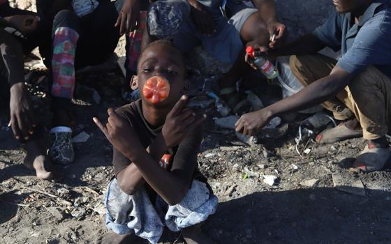 A child sniffs toxic glue from a plastic bottle on the streets of Mombasa, a coastal city in southeastern Kenya on the Indian Ocean. The high rate of youths using drugs has visibly affected their lives and the safety of the region. (GSR photo)