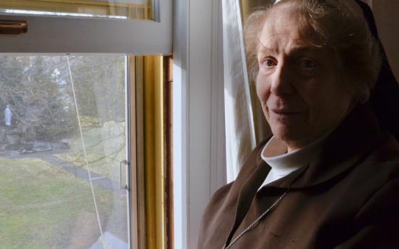 Sr. Marcia Kay LaCour, abbess of the Poor Clares in Spokane, Washington, at a window overlooking the grounds of the Monastery of St. Clare on Jan. 30 (GSR photo / Dan Stockman)