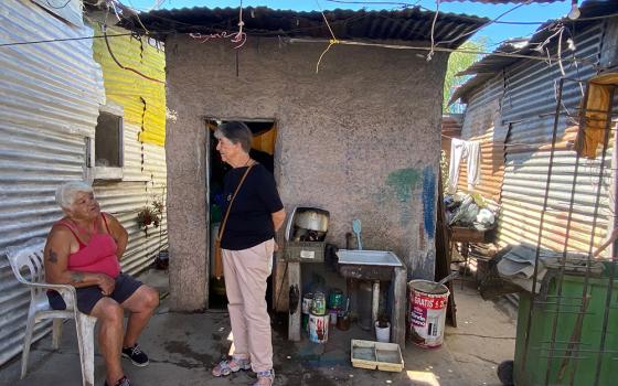 Passionist Sr. María Angélica Agorta visits with a woman in her home in Villa Hidalgo, Buenos Aires, Argentina. (GSR photo/Soli Salgado)