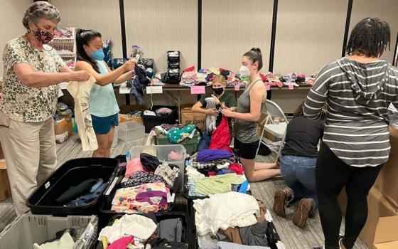 From left: St. Joseph Sr. Louise Ann Micek, Jaesen Evangelista, Emily Michaelis, Emma Shay, Nina Dorsett and Cindy Emenalo. In San Diego, we organized donated clothes for the refugees staying at the migrant hotel.