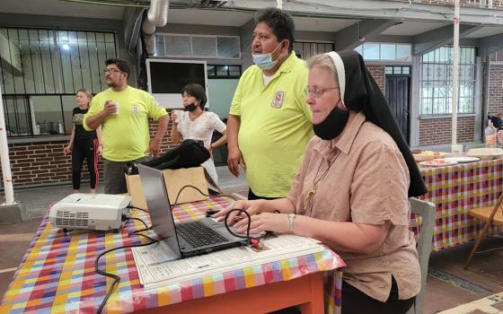 Felician Sr. Maria Louise Edwards (right), Ely Ortiz, president of the Aguilas del Desierto (center) and Aguilas volunteer Maurizio Vitela (left) give a presentation in June at a migrant shelter in Mexico City. (Courtesy photo)