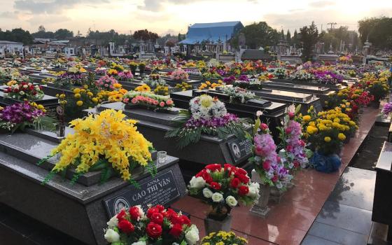 The graves of a parish cemetery in Ho Chi Minh are decorated with flowers in November. (Nguyen)