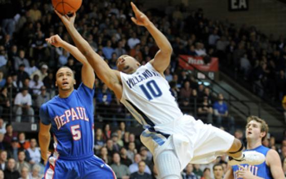 Villanova guard Corey Fisher tries to finish a shot while DePaul guard Nate Rogers looks on during a game in Villanova, Pa., Nov. 29. (Zuma Press/SCG/Mike McAtee)