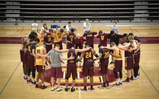 Sr. Jean Dolores Schmidt prays with the Loyola University Chicago men's basketball team in 2018. (CNS/Courtesy of Loyola University Chicago/Bill Behrns)