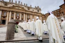 Long double-row of anonymous, vested bishops shown from behind file into looming edifice of St. Peter's. 