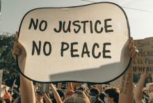 A sign that says "No Justice, No Peace" (Unsplash/Clay Banks)